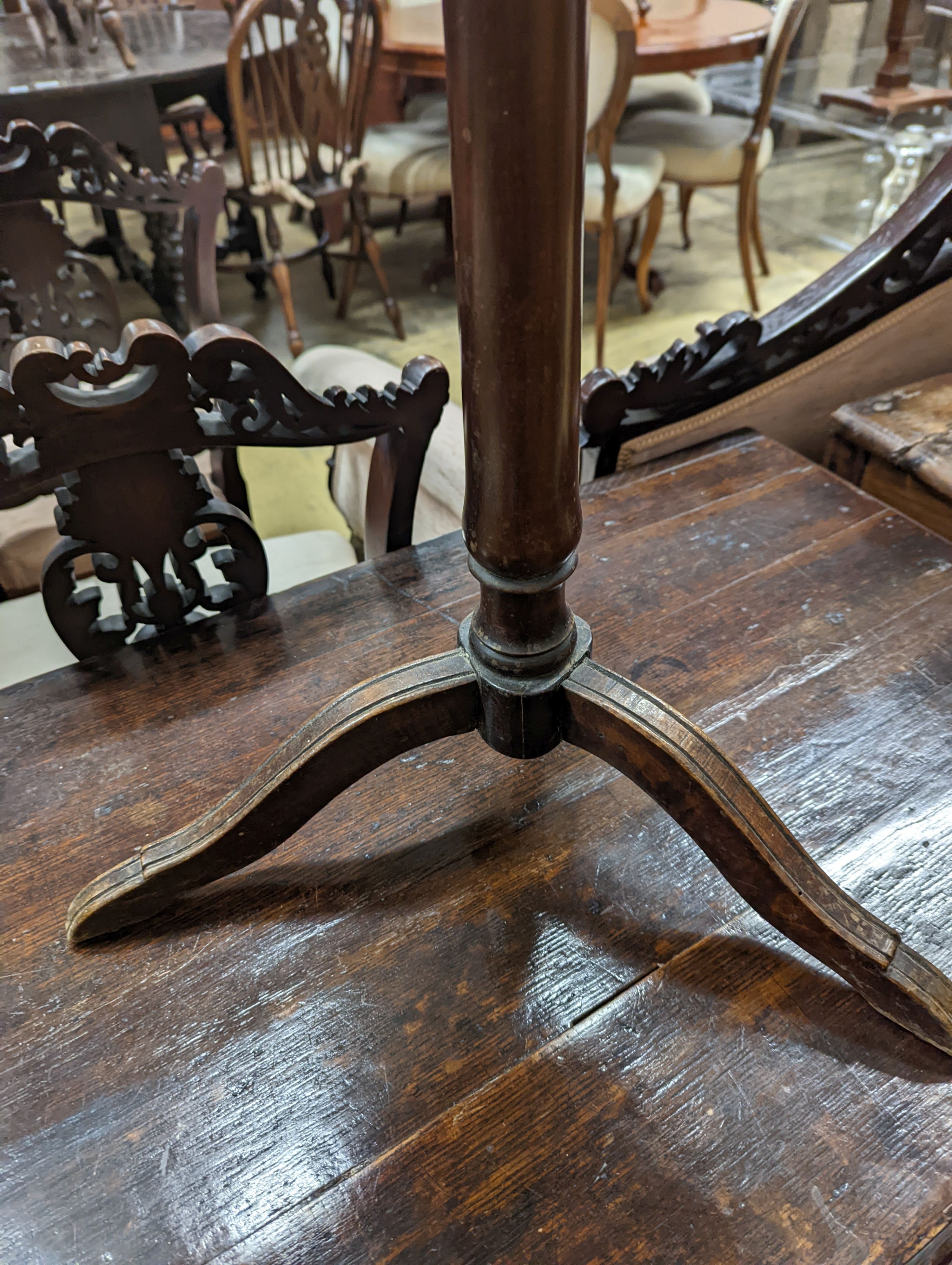 An early 19th century primitive circular tripod table, diameter 42cm, height 73cm